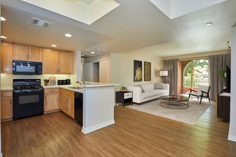 A modern kitchen with wooden cabinets and a white island.