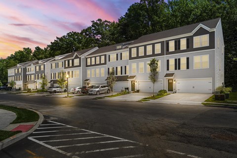 A large building with a parking lot in front of it. at Heritage at Mount Holly, Mount Holly