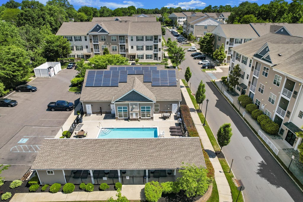 A large building with a pool and solar panels on the roof.