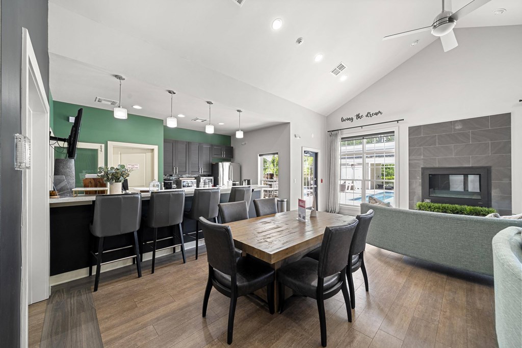 A modern dining room with a wooden table and chairs.