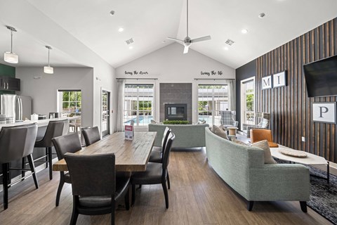 A modern living room with a dining table and chairs.