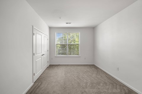 A room with a carpeted floor at Heritage at Mount Holly, New Jersey