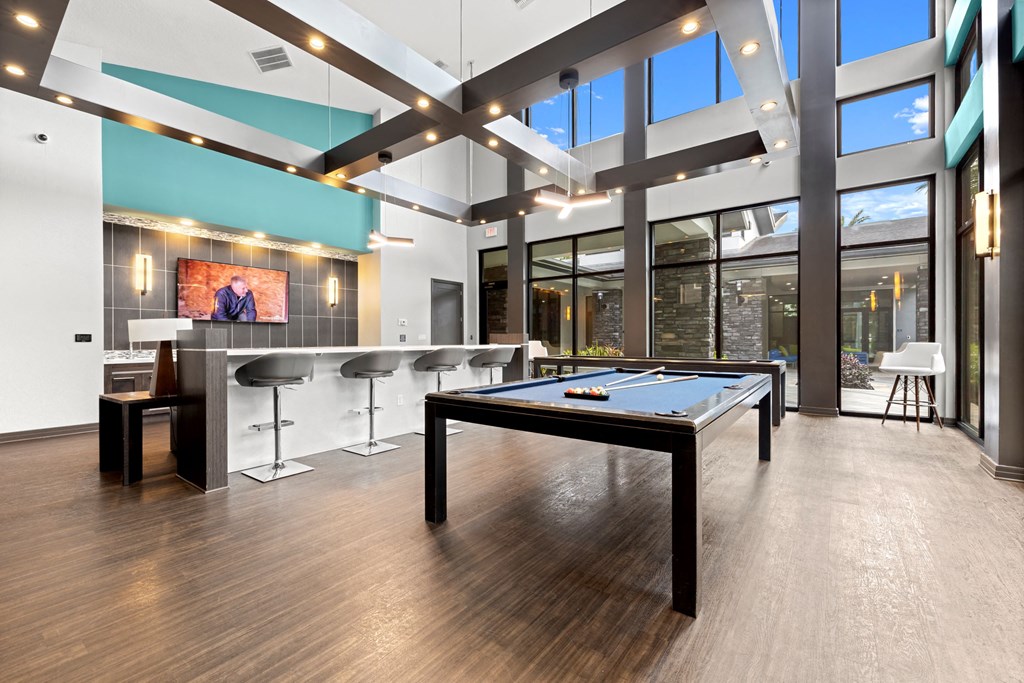 a game room with a pool table and a bar at Pearce at Pavilion Luxury Apartments, Riverview, 33578