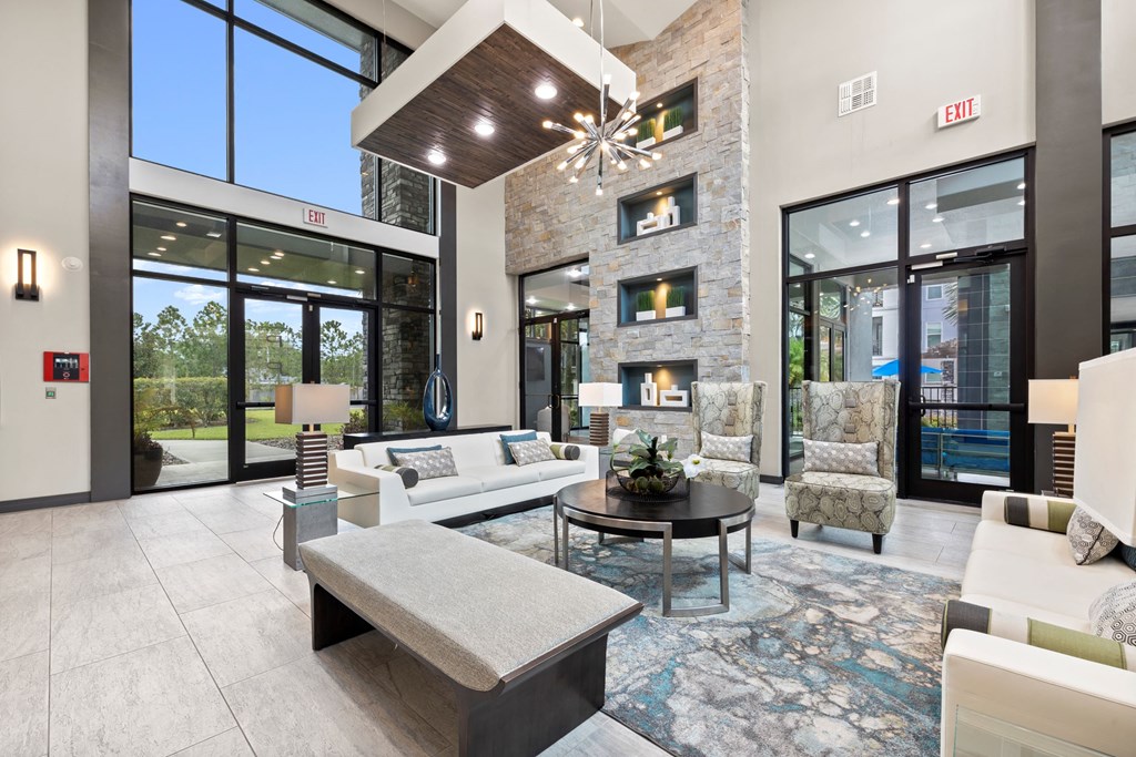 a living room with couches and chairs and a fireplace at Pavilion Luxury Apartments, Riverview, FL, Florida