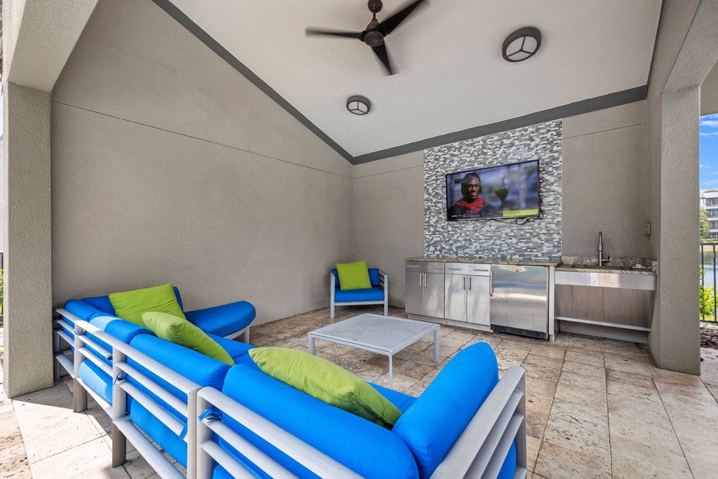 a living room with couches and a table and a tv at Pavilion Luxury Apartments, Riverview, FL, 33578