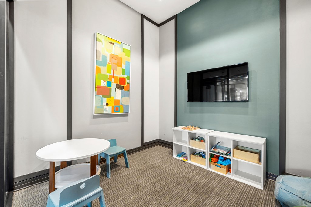 a room with a table and chairs and a television at Pearce at Pavilion Luxury Apartments, Florida, 33578