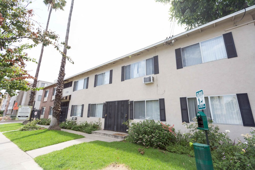 side view of the building with grass and walkway