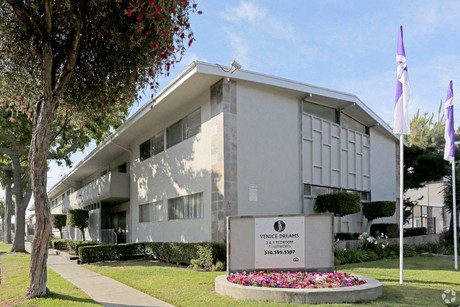 a white building with a sign in front of it