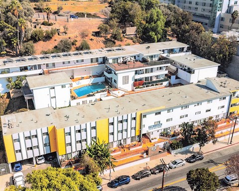 A large white building with a pool in the middle.