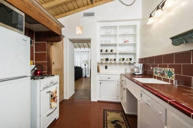 Villa Valentino 12 Kitchen with red tiles and white built in open storage nook in the back