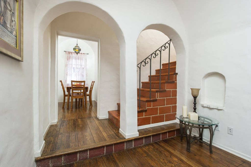 Villa Valentino 14 Dining Room and a brown staircase with arched ceilings