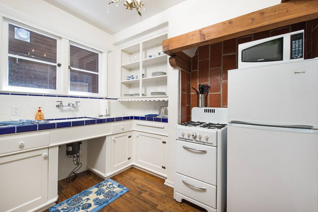 Villa Valentino 14 Kitchen with blue tile counters and white cabinetry
