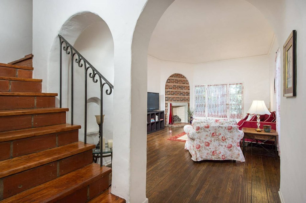 Villa Valentino 14 Living Room Stairs and a view of the living room with the red couch and white trim