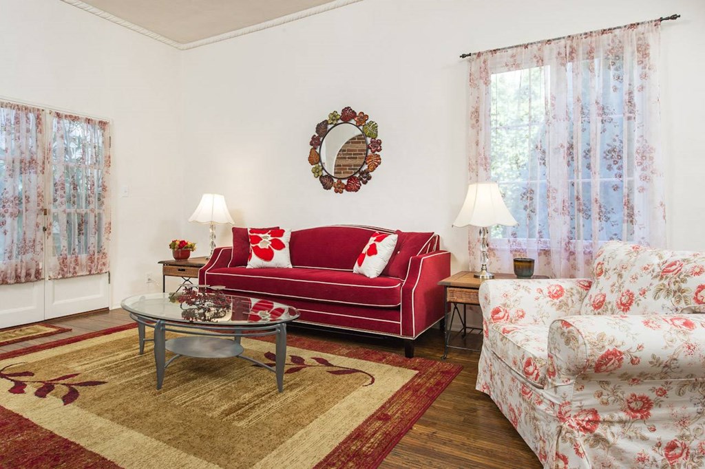 Villa Valentino 14 Living Room with red loveseat and floral chair and floral curtains