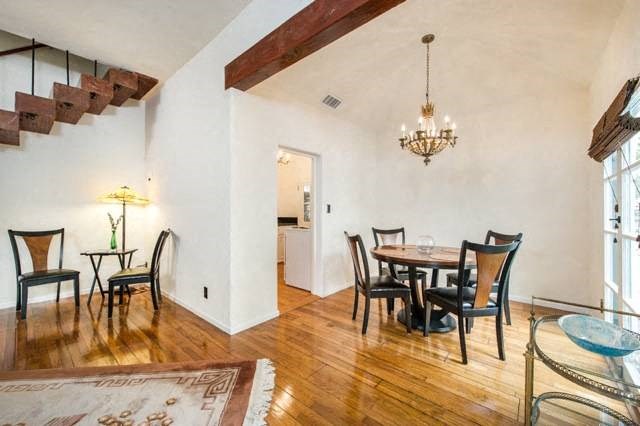 Villa Valentino 17 Dining Room with view of staircase and wooden beam over entryway of dining room.
