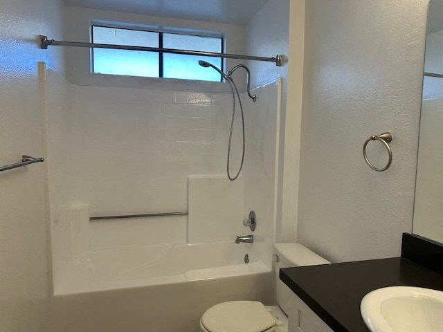 a bathroom with a shower and a sink and a toilet