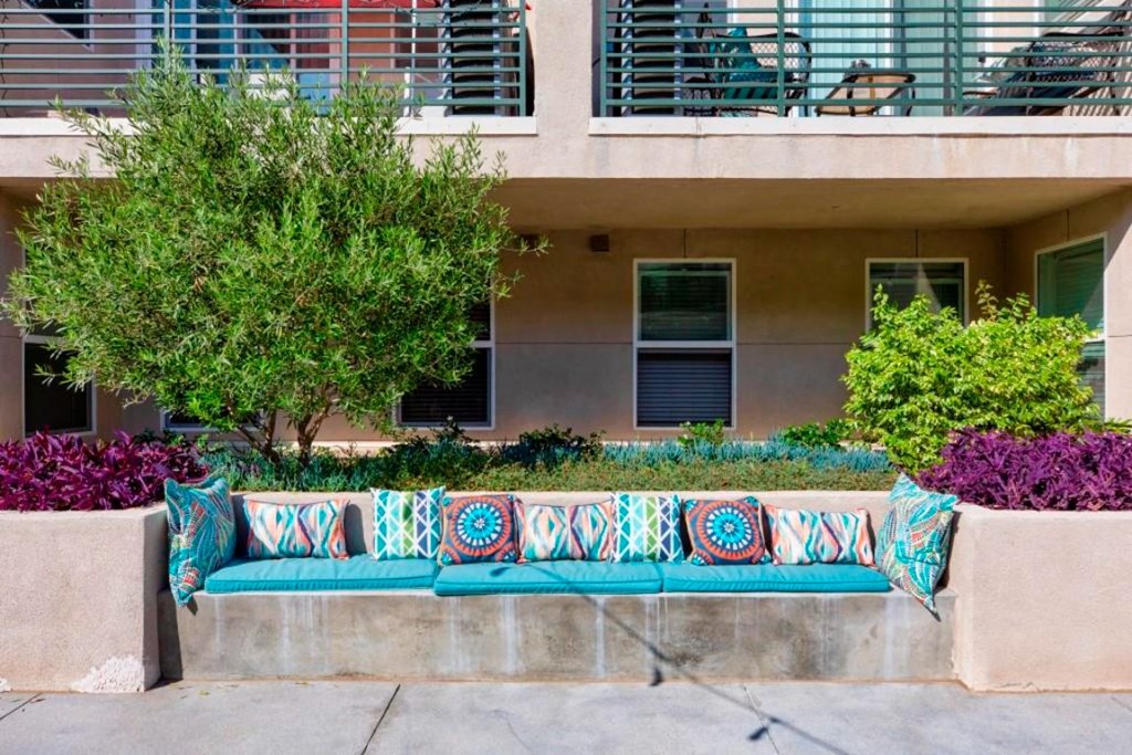 outdoor seating area with blue cushions and pillows