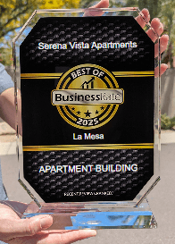A person is holding a glass award that says Serena Vista Apartments.