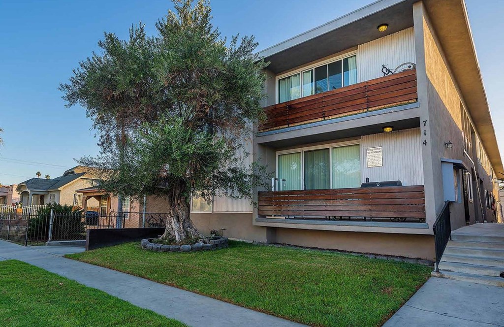 Front of building with tree and sidewalk