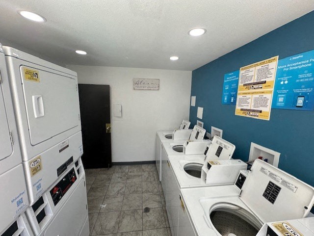 a laundry room with a bunch of washes and dryers