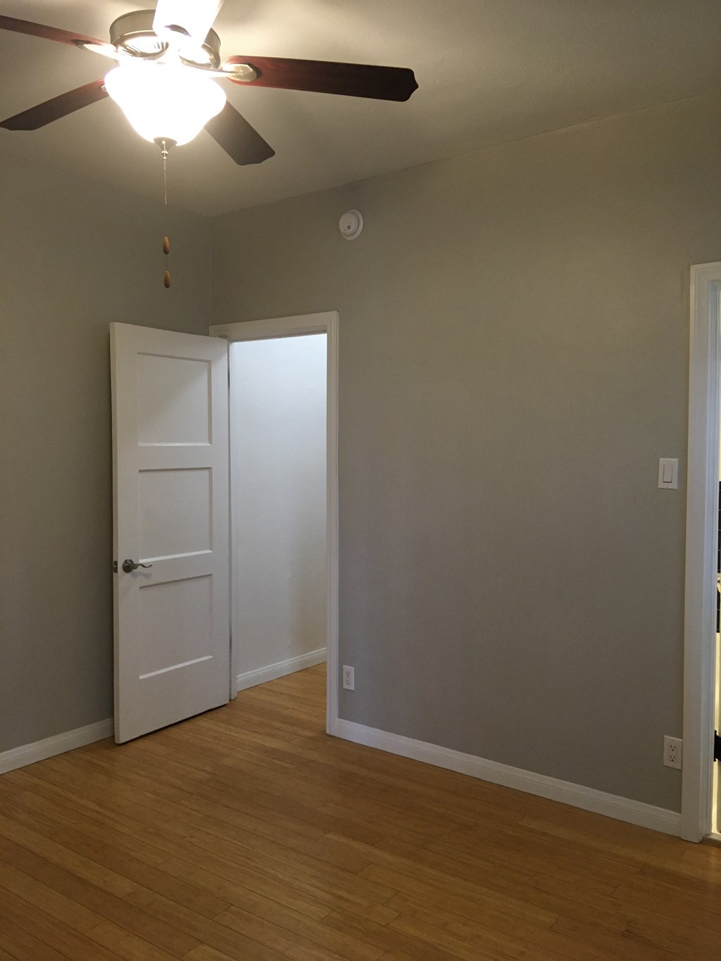 Empty bedroom with hardwood floors