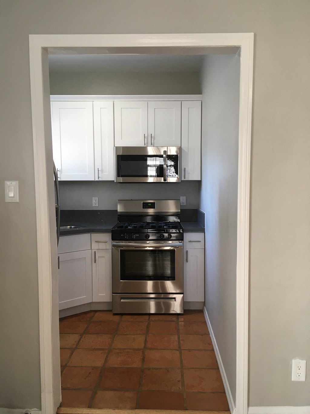 Kitchen view of microwave and stove