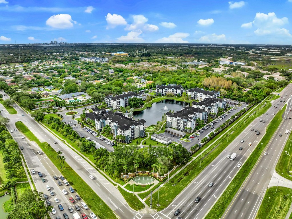 Aerial view of a city with a pond and cars on the road at Pearce at Pavilion Luxury Apartments, Riverview