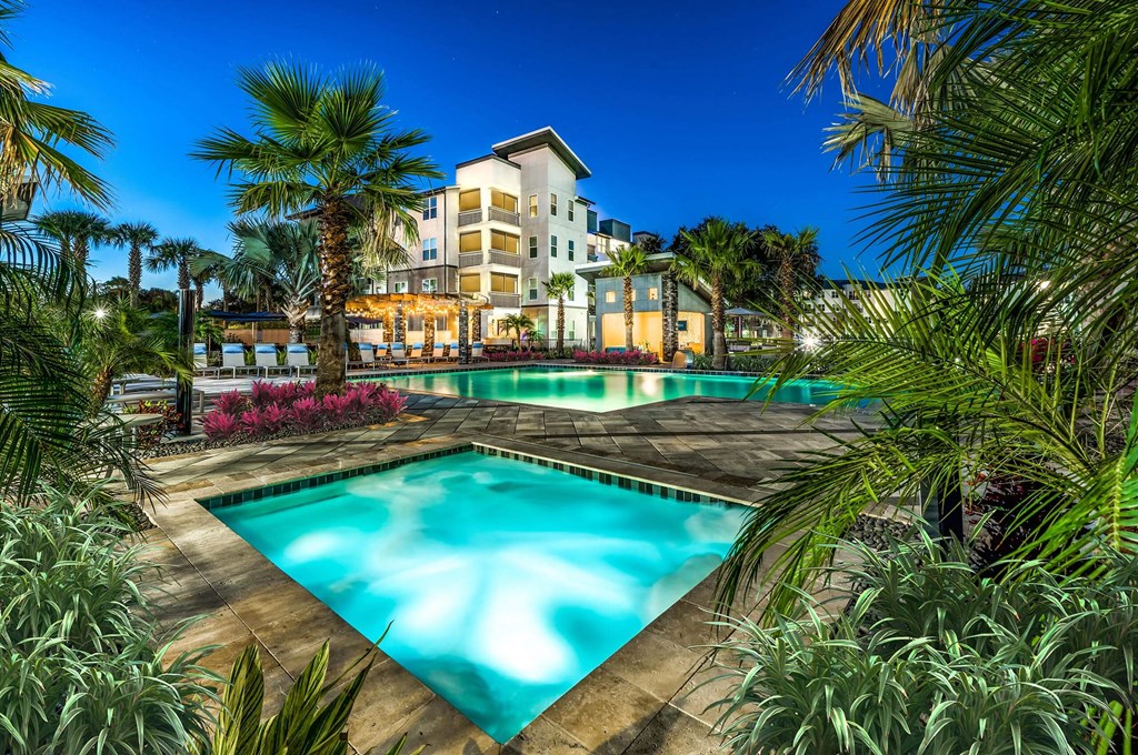 Large swimming pool with palm trees at Pearce at Pavilion Luxury Apartments, Riverview, 33578