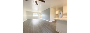 A room with a ceiling fan and light fixture.