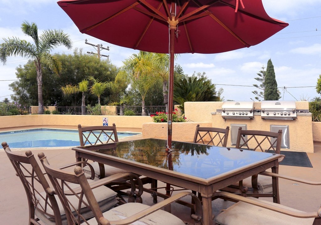 a patio with a table and chairs and an umbrella