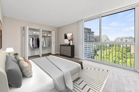 A bedroom with a large bed and a view of the city.