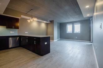 kitchen and living room in a bedroom plus den unit. - Photo Gallery