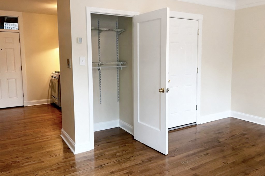 a bedroom with a closet and a door open