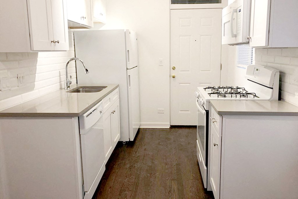 a kitchen with white appliances and white cabinets