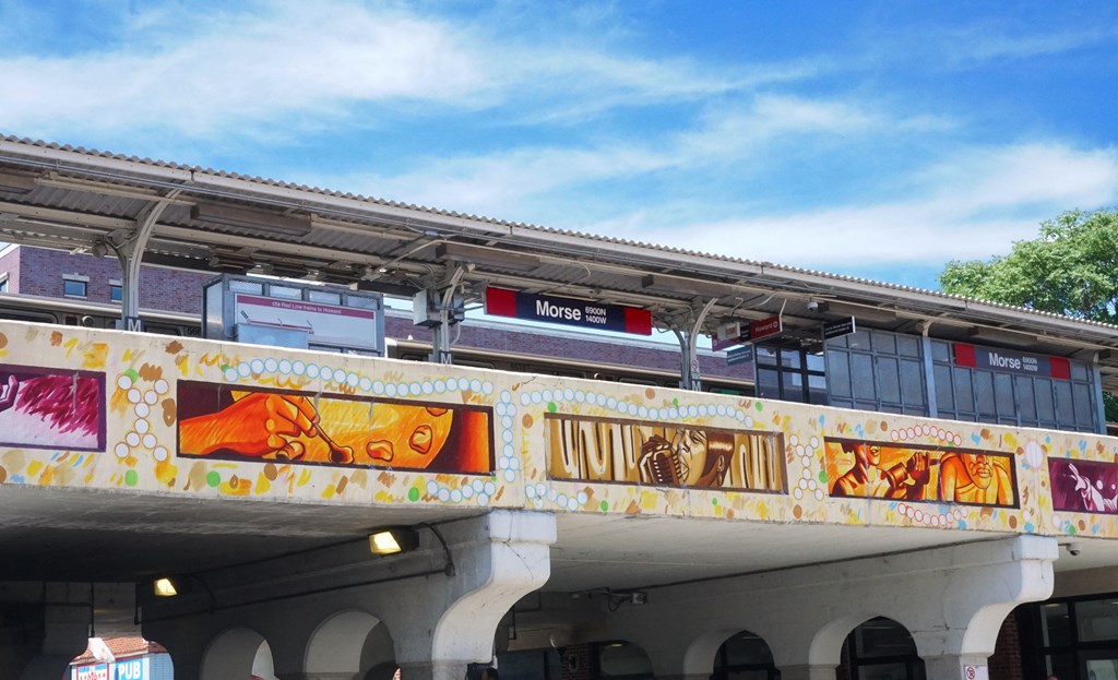 a train on a bridge with a blue sky in the background