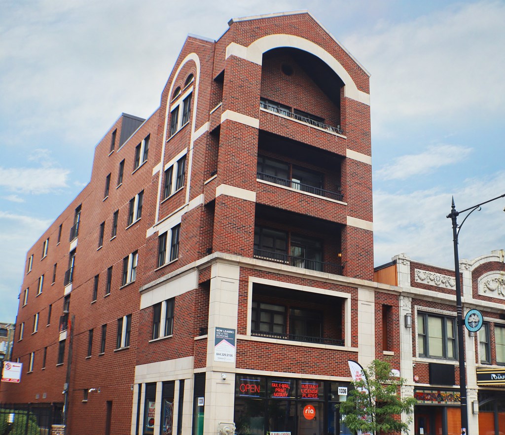 a tall red brick building with a rounded top
