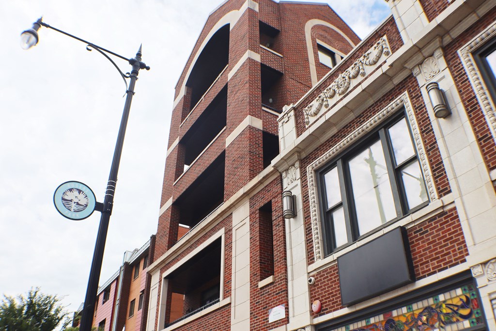 a tall brick building with a clock on the side of it