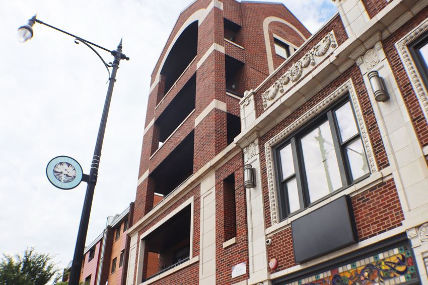 a tall brick building with a clock on the side of it - Photo Gallery