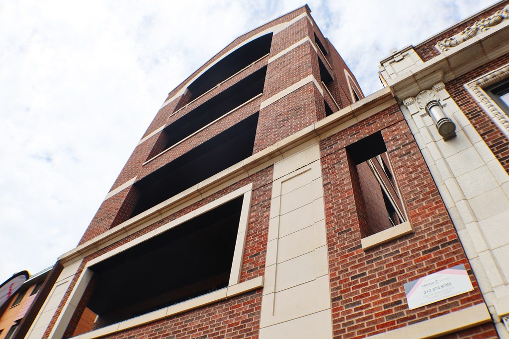 a view of the top of a brick building with a cloudy sky in the background