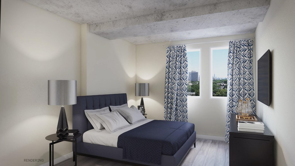 a bedroom with a bed and two windows