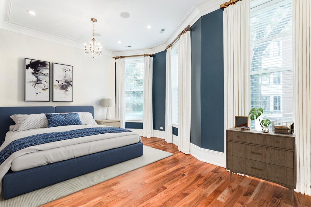 a bedroom with blue and white walls and a bed