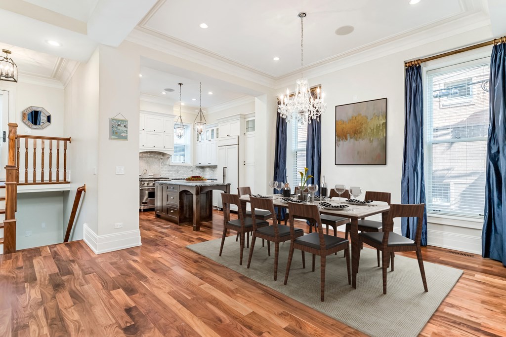 a dining room with a wooden table and chairs