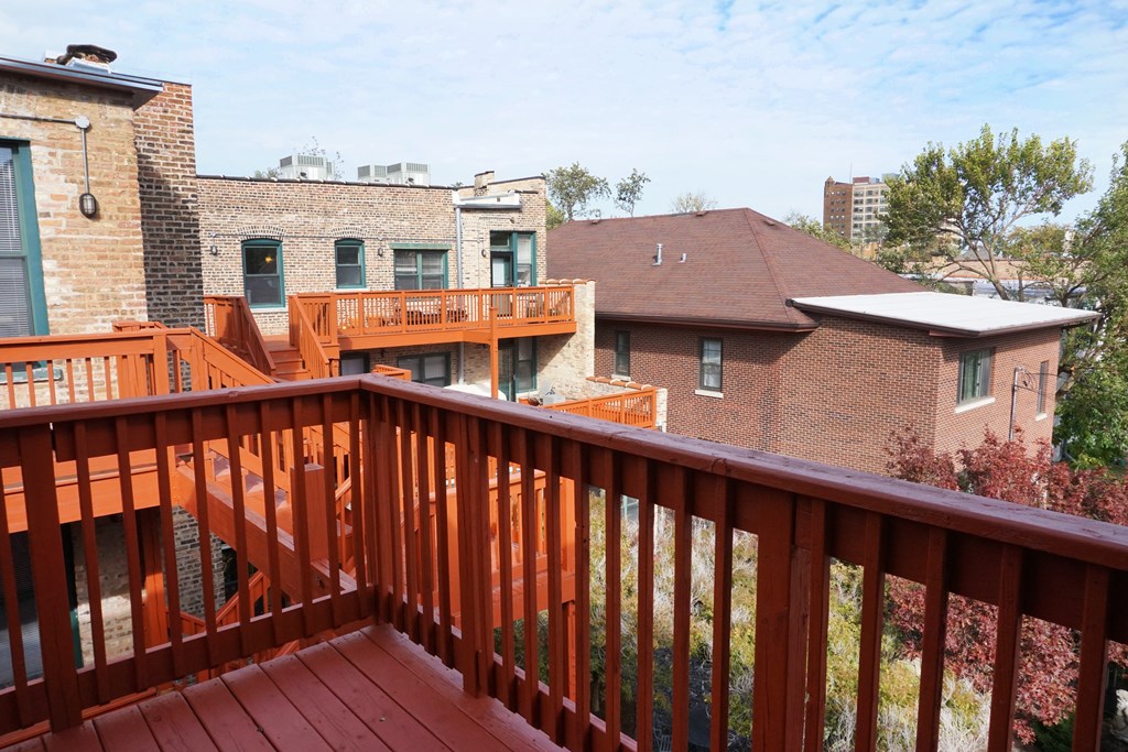 the view from the deck of a home with a red railing