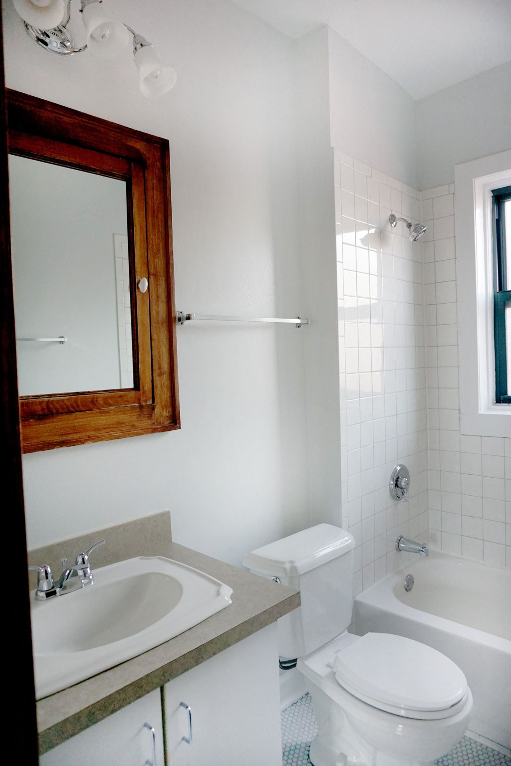 a small bathroom with a toilet sink and bathtub
