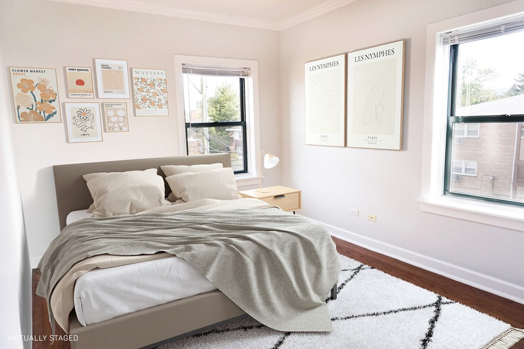 a bedroom with a bed and pictures on the wall