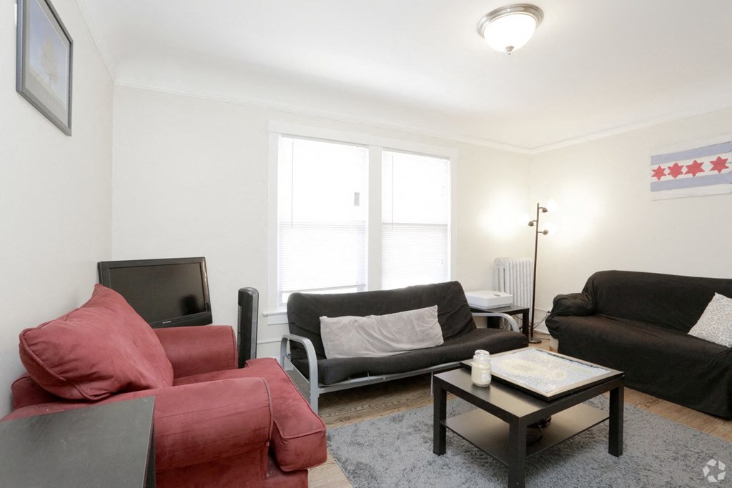 a living room with two couches a coffee table and a tv