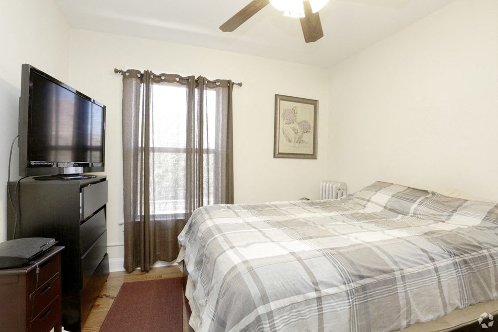 a bedroom with a bed and a tv