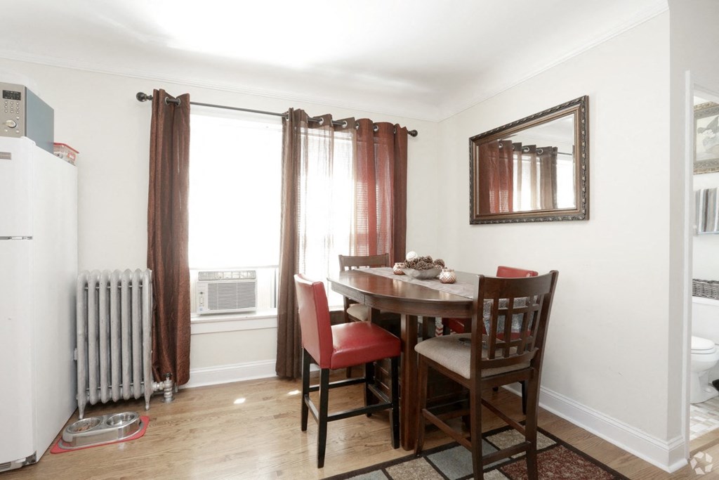 a dining room with a table and chairs and a radiator