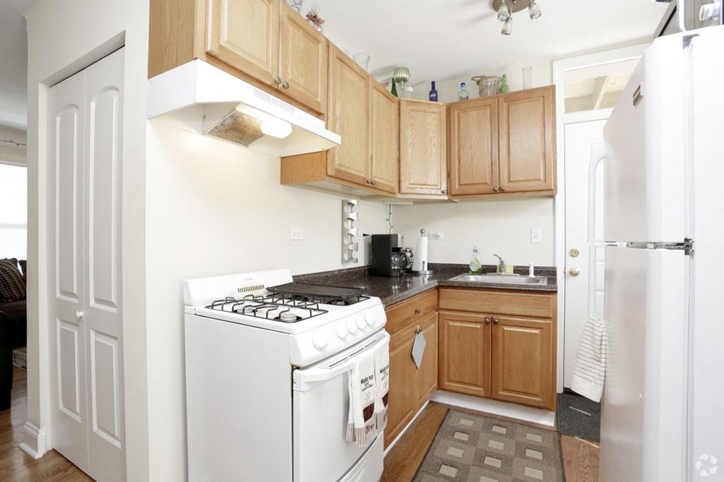 a kitchen with wooden cabinets and white appliances