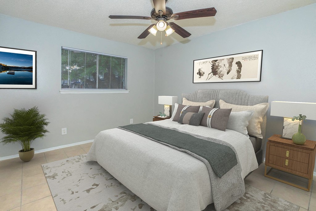 a bedroom with a bed and a ceiling fan